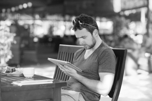Man outdoor cafe with tablet - WEB BW